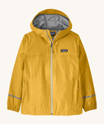 The Patagonia Little Kids Torrentshell 3L Waterproof Jacket in a yellow colour on a cream background.