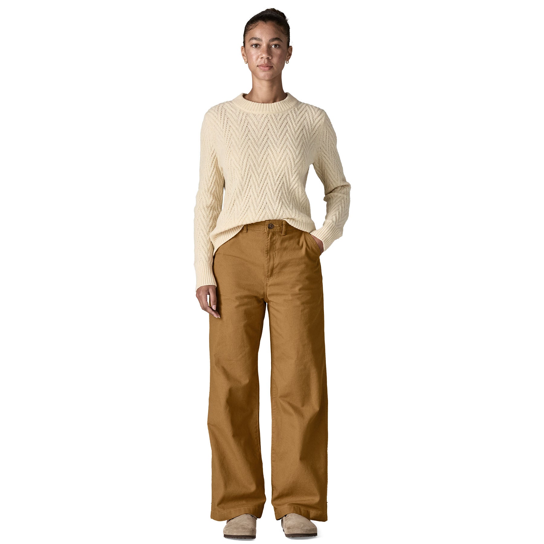 A woman wearing the Patagonia women's trousers available at Babipur. A wide leg style canvas trousers in nest brown colour, features a button fastener and 2 side pockets. 
