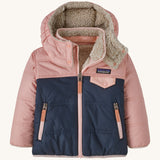 Patagonia little kids tribbles hoody. A reversible coat showing a pink and navy hooded coat and natural fleece inner for warmth. Features a small chest pocket with popper fastening and 2 side zip pockets