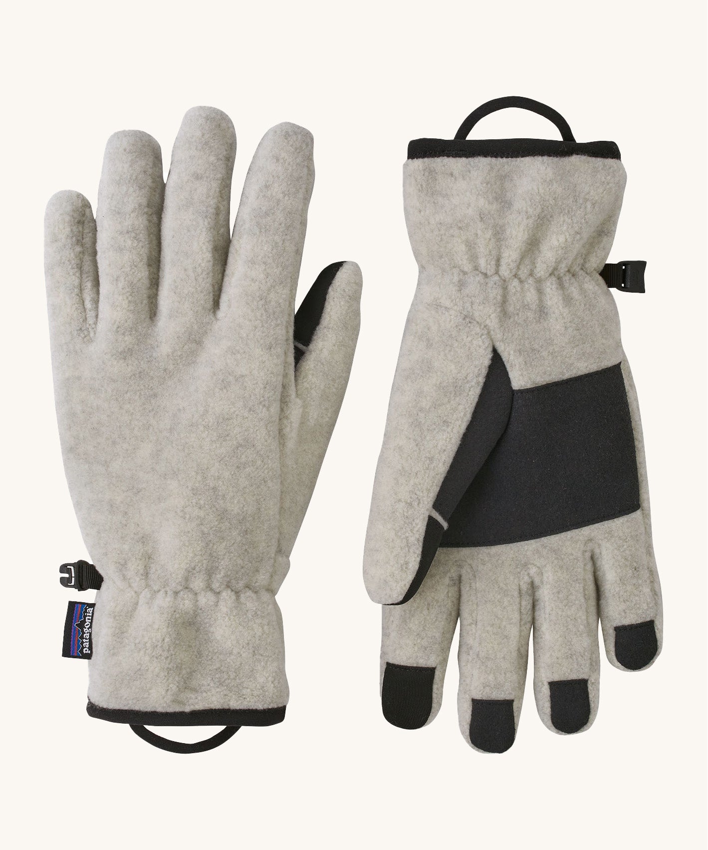 Patagonia adult synchilla gloves in oatmeal heather. Features a grip on the palms and fingertips. Logo label is stitched on the side . 