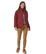 A woman wearing the Patagonia off slope womens carmine red jacket with a brand logo.