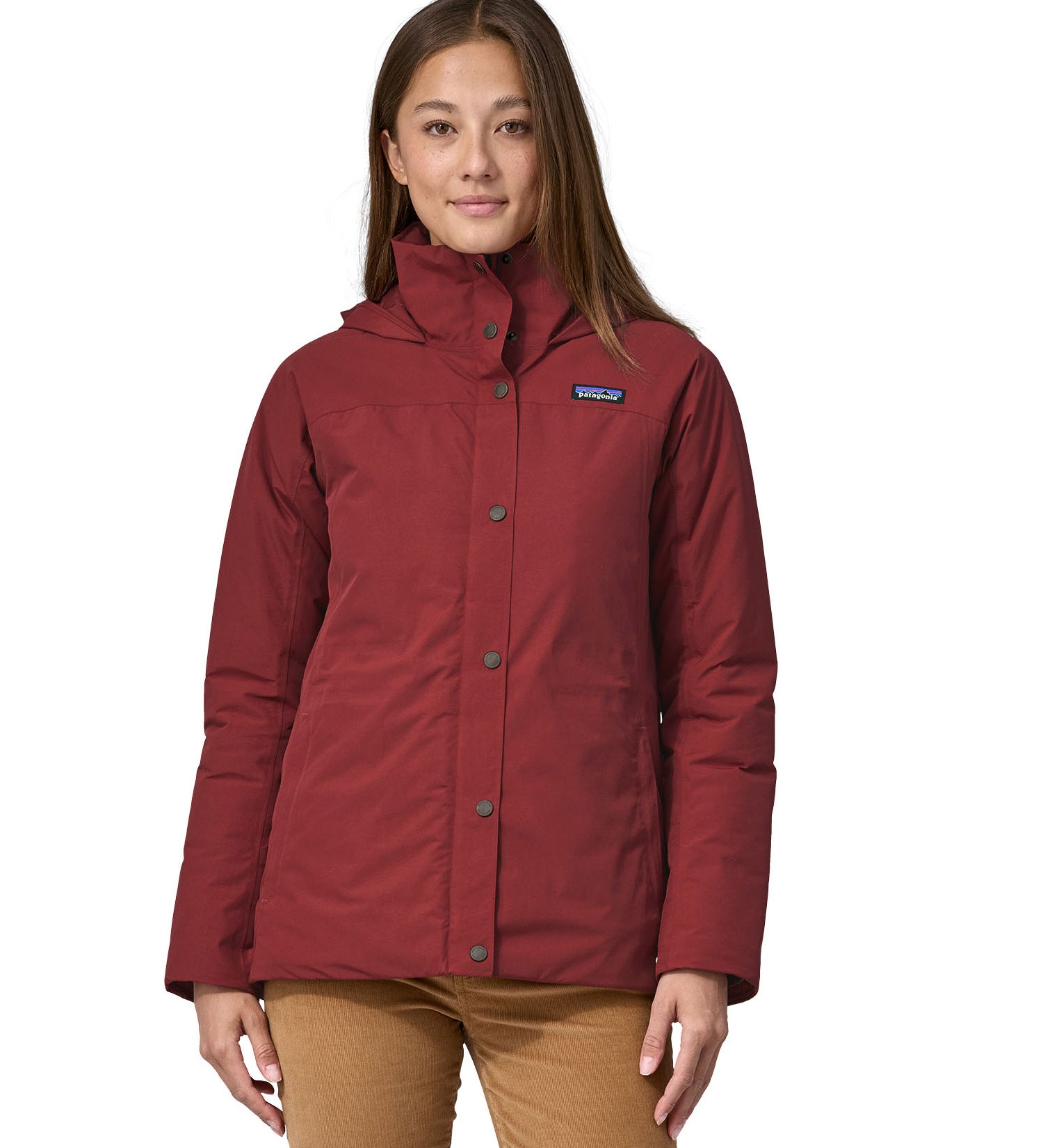 A woman wearing the Patagonia off slope womens carmine red jacket with a brand logo.