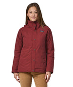 A woman wearing the Patagonia off slope womens carmine red jacket with a brand logo.