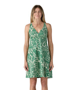 Model wearing the Patagonia Amber Dawn dress that has a green floral / leafy pattern.
