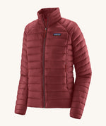 Patagonia women's down sweater jacket in oxide red colour on a cream background.