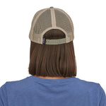 view of the back of a person wearing a Patagonia P-6 Logo LoPro Trucker Hat in a stone beige colour way