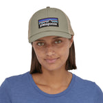 view of the front of a person wearing a Patagonia P-6 Logo LoPro Trucker Hat in a stone beige colour way