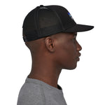 A side profile image of a man wearing the Patagonia P-6 Logo Trucker Hat in a Black colour