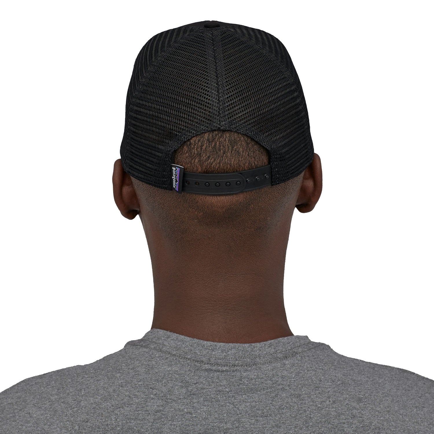 A back profile image of a man wearing the Patagonia P-6 Logo Trucker Hat in a Black colour