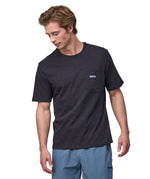 Patagonia men's short sleeve top with a pocket on the front in a black worn by a man