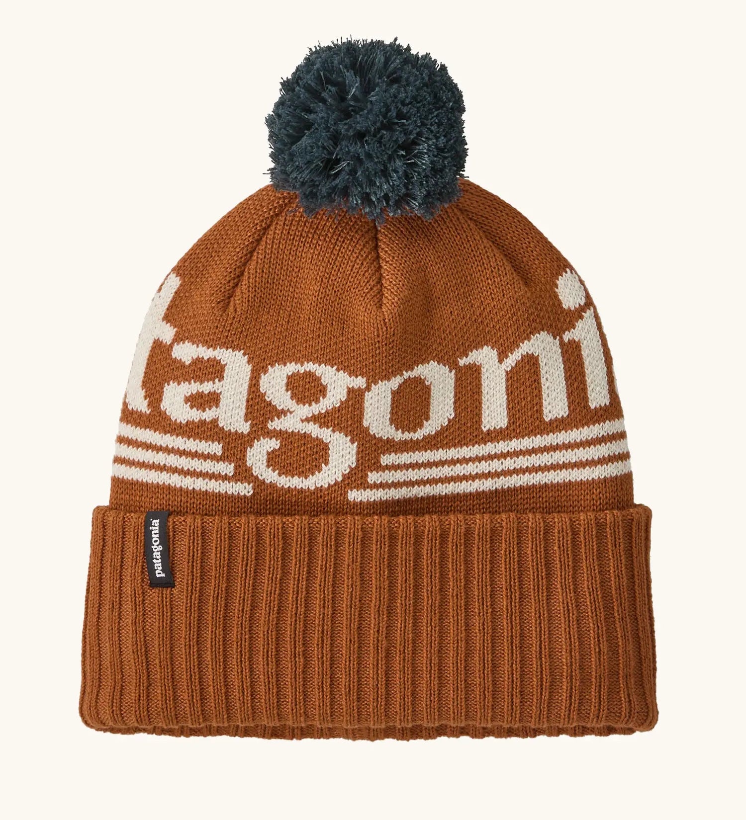 Patagonia powder town recycled knit bobble hat beanie with a hut tripper logo in cinnamon brown. 