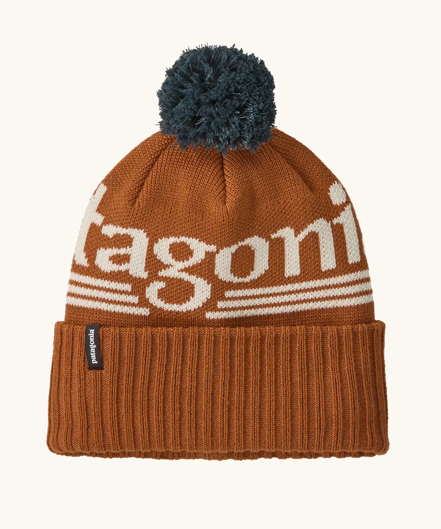 Patagonia powder town recycled knit bobble hat beanie with a hut tripper logo in cinnamon brown. 