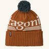 Patagonia powder town recycled knit bobble hat beanie with a hut tripper logo in cinnamon brown. 