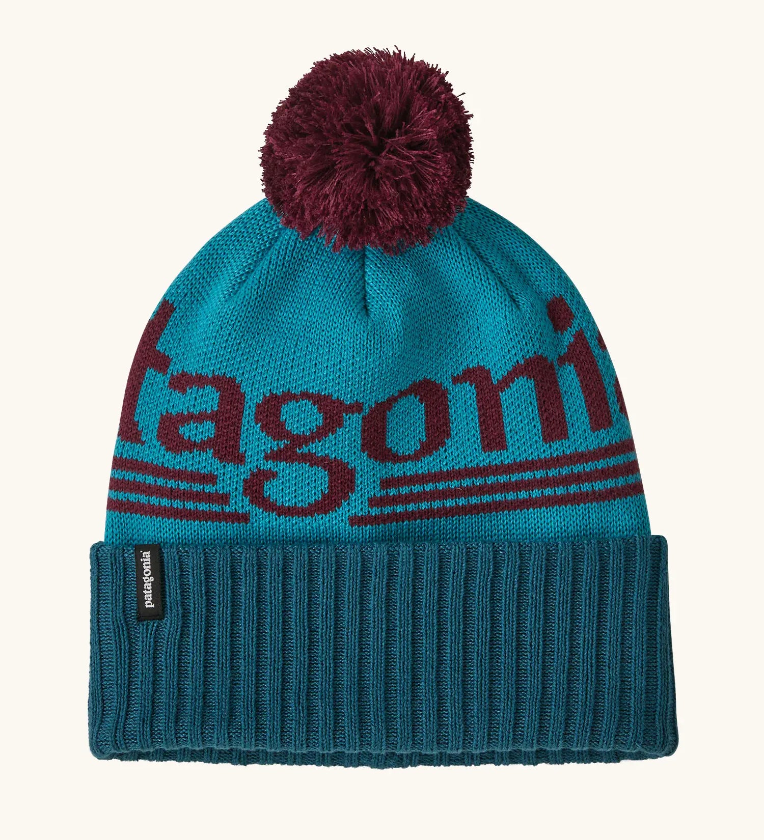 Patagonia powder town recycled knit bobble hat beanie with a hut tripper logo in mako blue. 