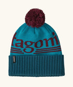 Patagonia powder town recycled knit bobble hat beanie with a hut tripper logo in mako blue. 