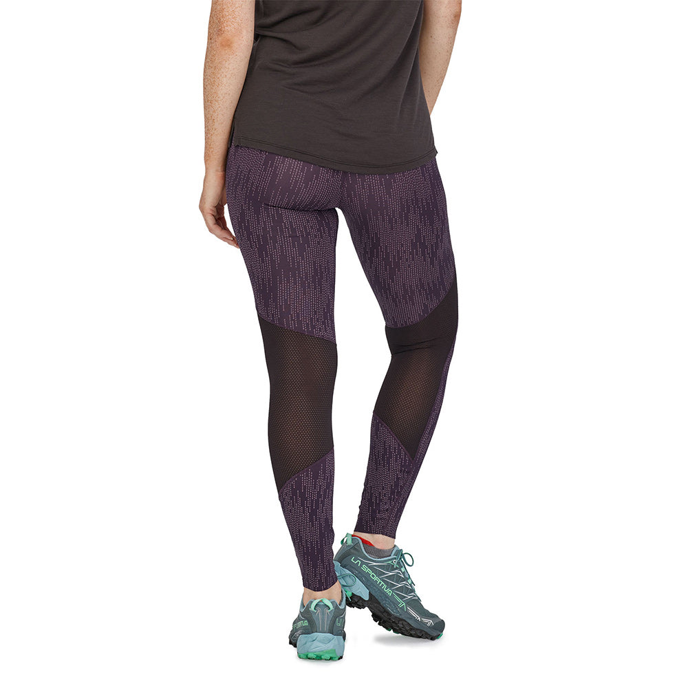 Woman facing backwards wearing the Patagonia recycled running bottoms on a white background