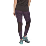 Woman facing backwards wearing the Patagonia recycled running bottoms on a white background