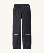 Patagonia kids torrentshell rain trousers back detail on a cream background.