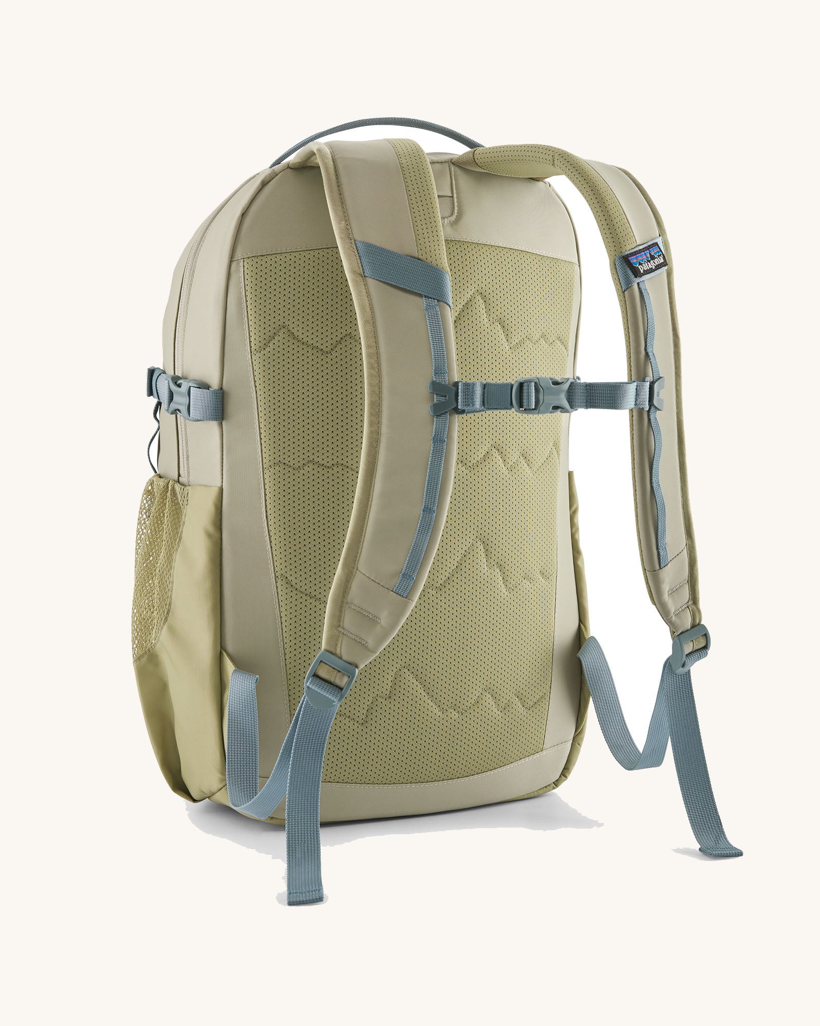 Back of the Patagonia 26L refugio backpack in stone with grey chest strap and quick release buckle.
