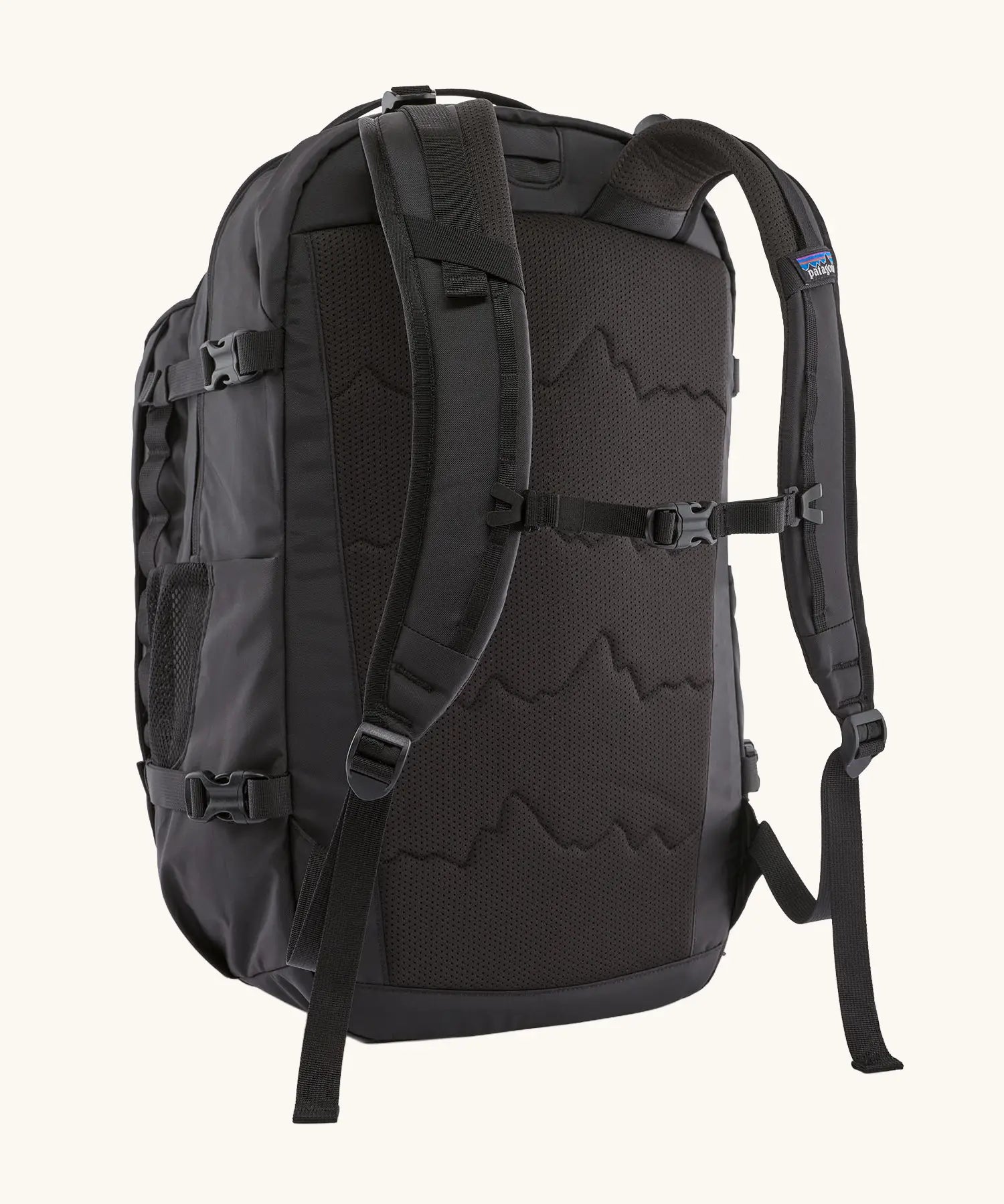 Back of the Patagonia refugio day pack 32 litre backpack in black showing the chest strap closed.