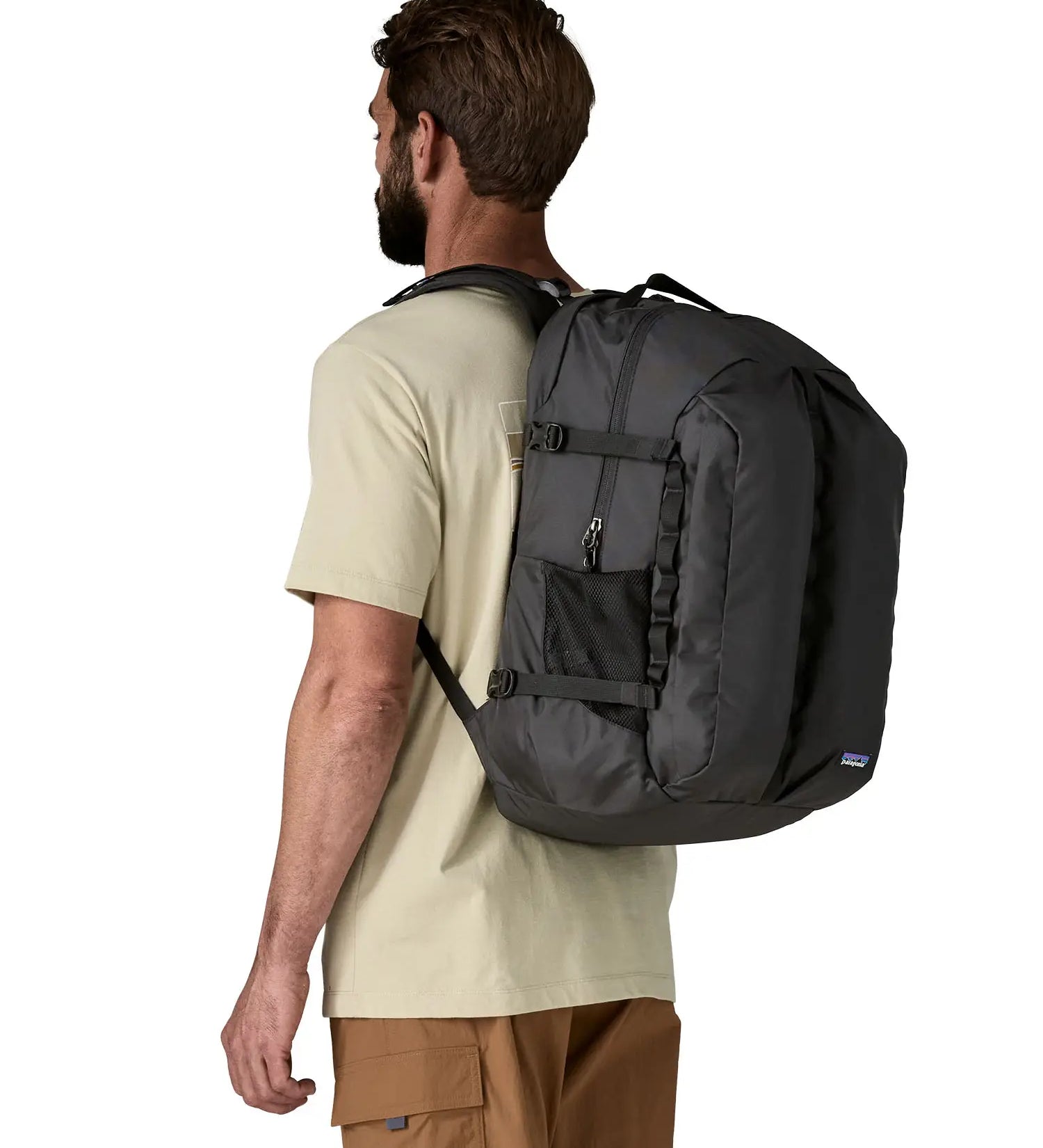Man wearing the Patagonia refugio day pack 32 litre backpack in black. 