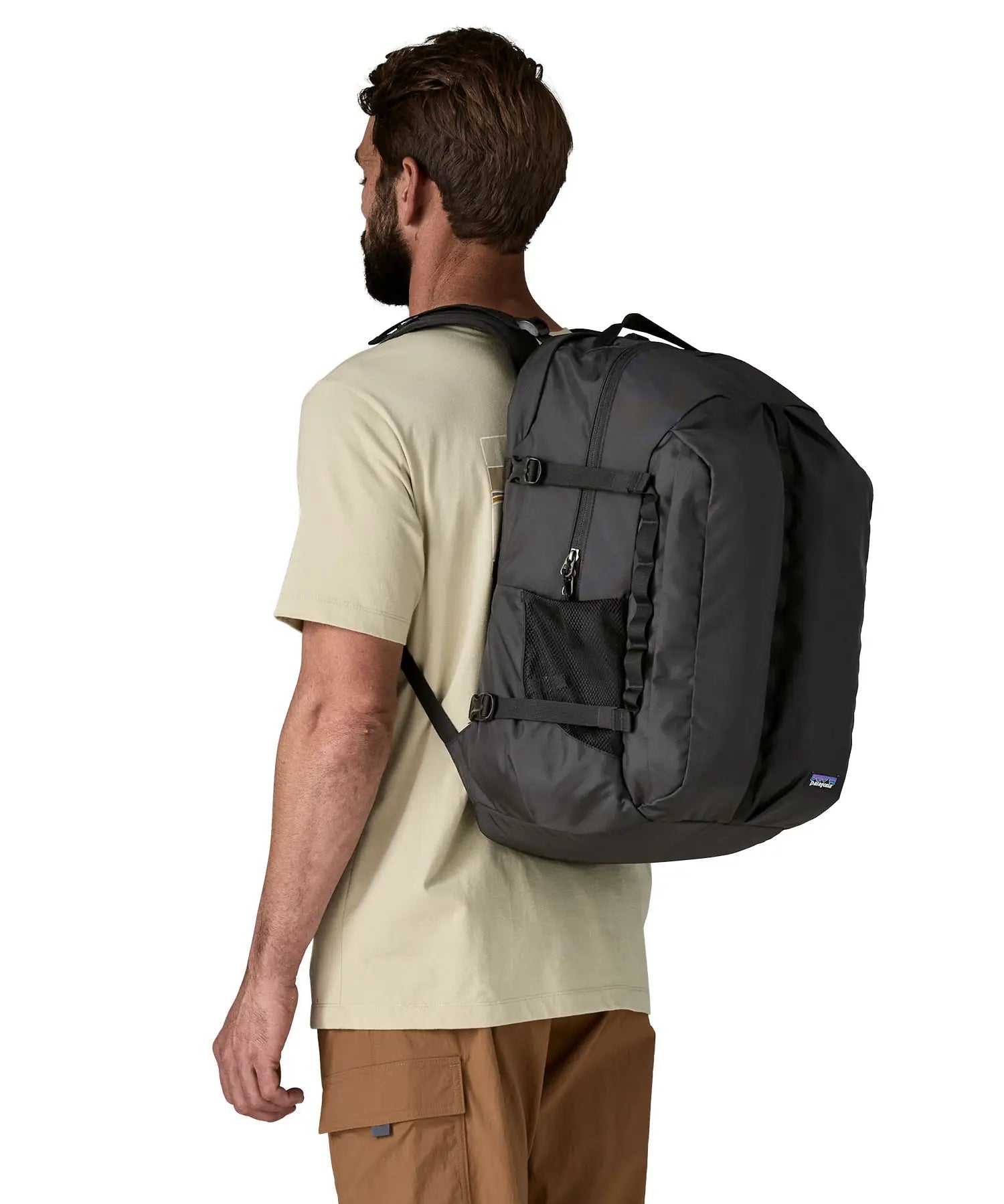 Man wearing the Patagonia refugio day pack 32 litre backpack in black. 