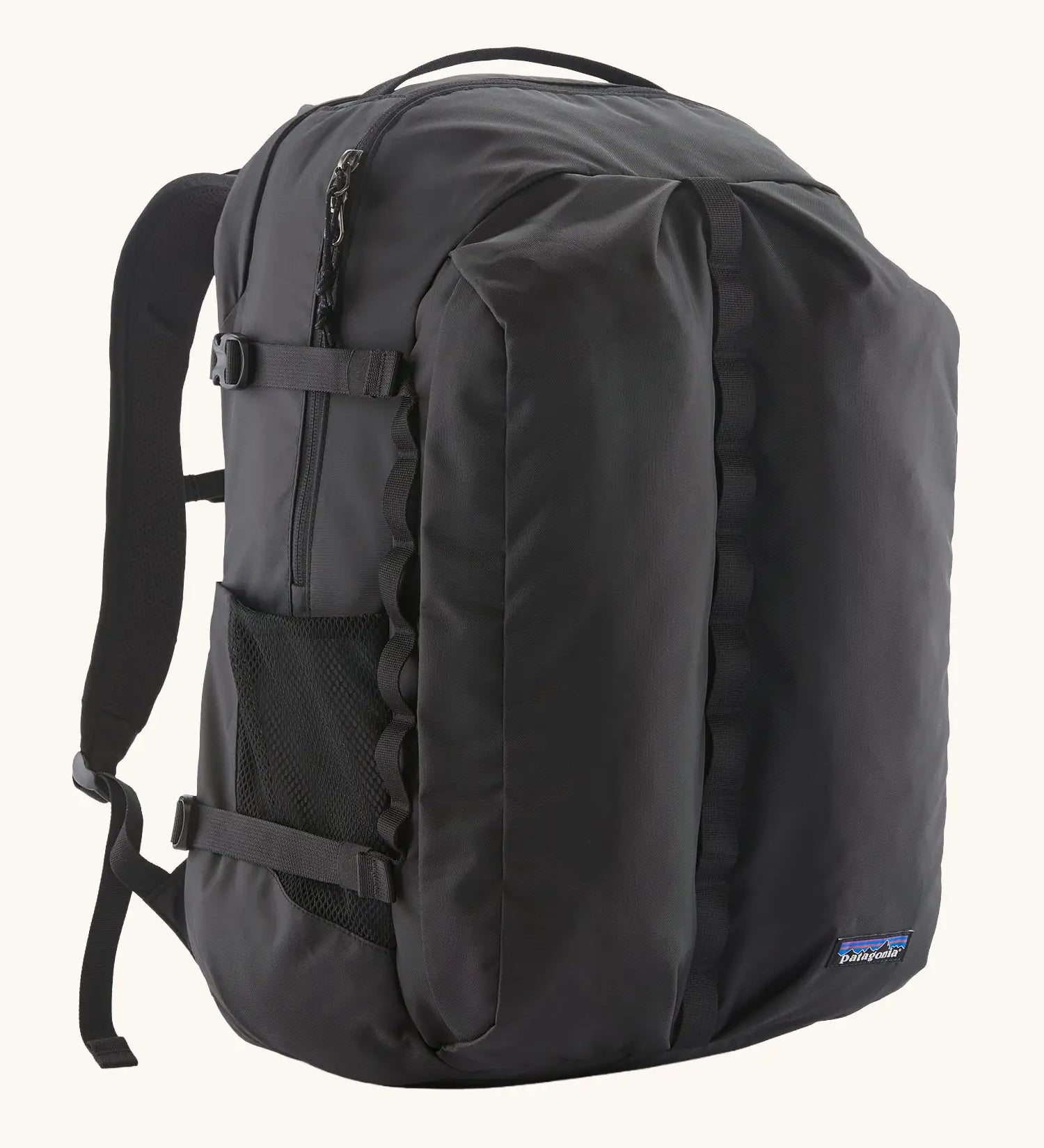 Patagonia refugio day pack 32 litre backpack in black. One large main zipped compartment with two pockets and bottle holders on the side. 