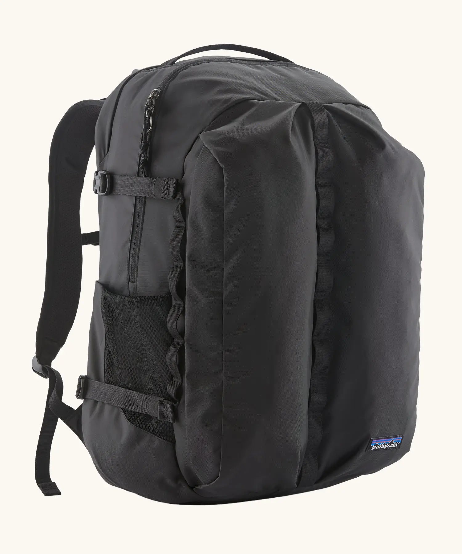 Patagonia refugio day pack 32 litre backpack in black. One large main zipped compartment with two pockets and bottle holders on the side. 