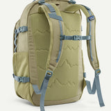 Back of the Patagonia refugio 32L daypack in weathered stone light green and blue trim. Padded straps and quick release buckle chest strap.