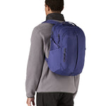 Patagonia purple 26L day refugio backpack worn by an adult 