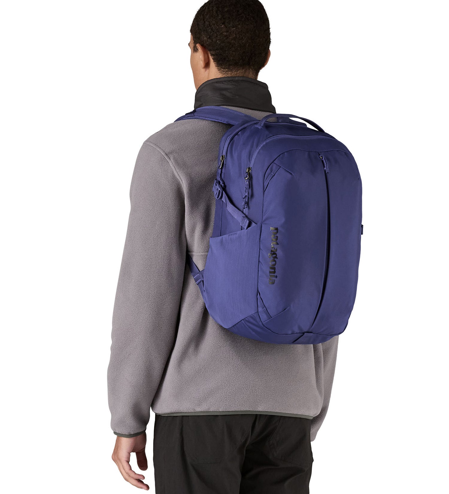 Patagonia purple 26L day refugio backpack worn by an adult 