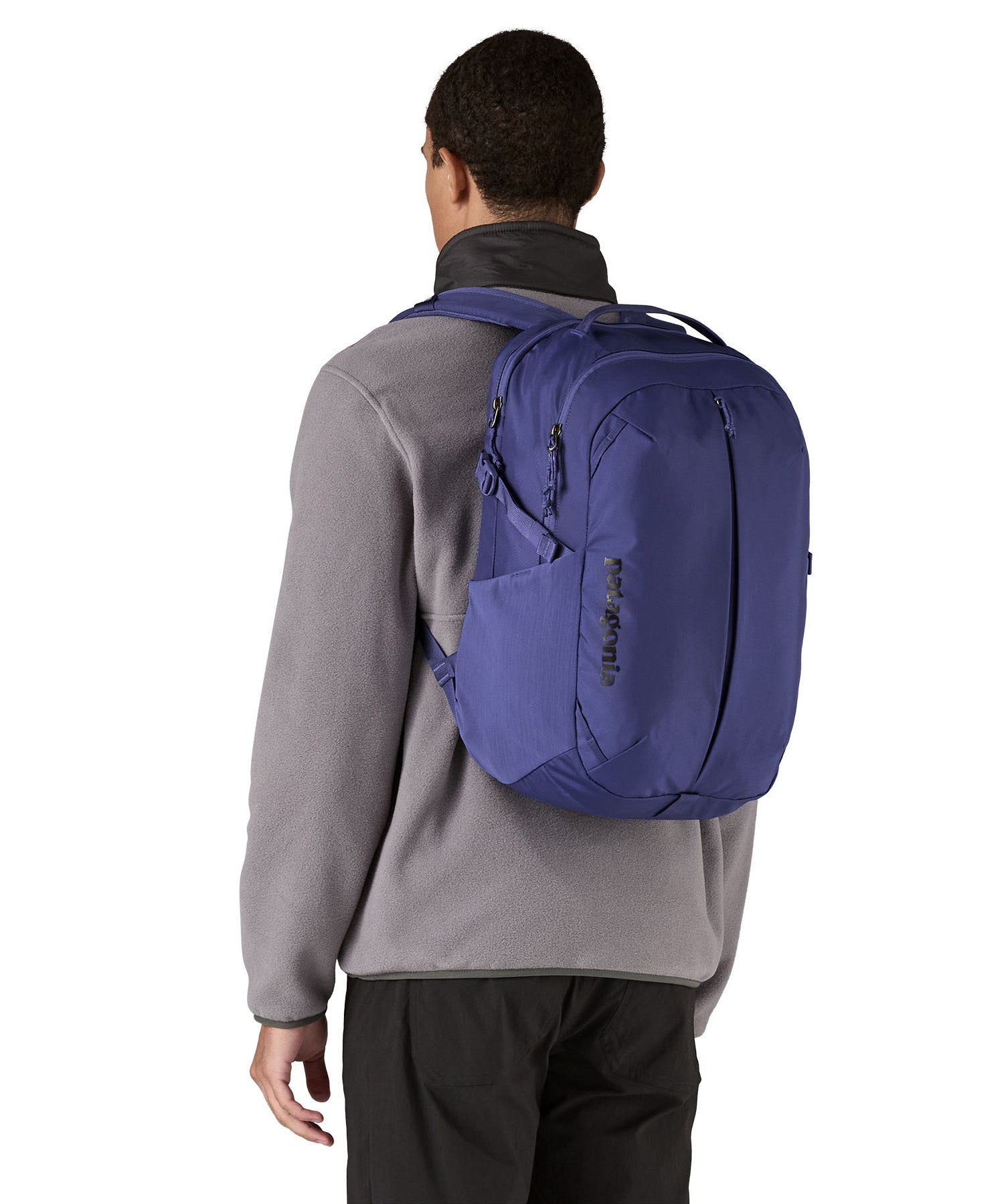 Patagonia purple 26L day refugio backpack worn by an adult 