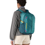 Patagonia turquoise 26L day refugio backpack worn by an adult