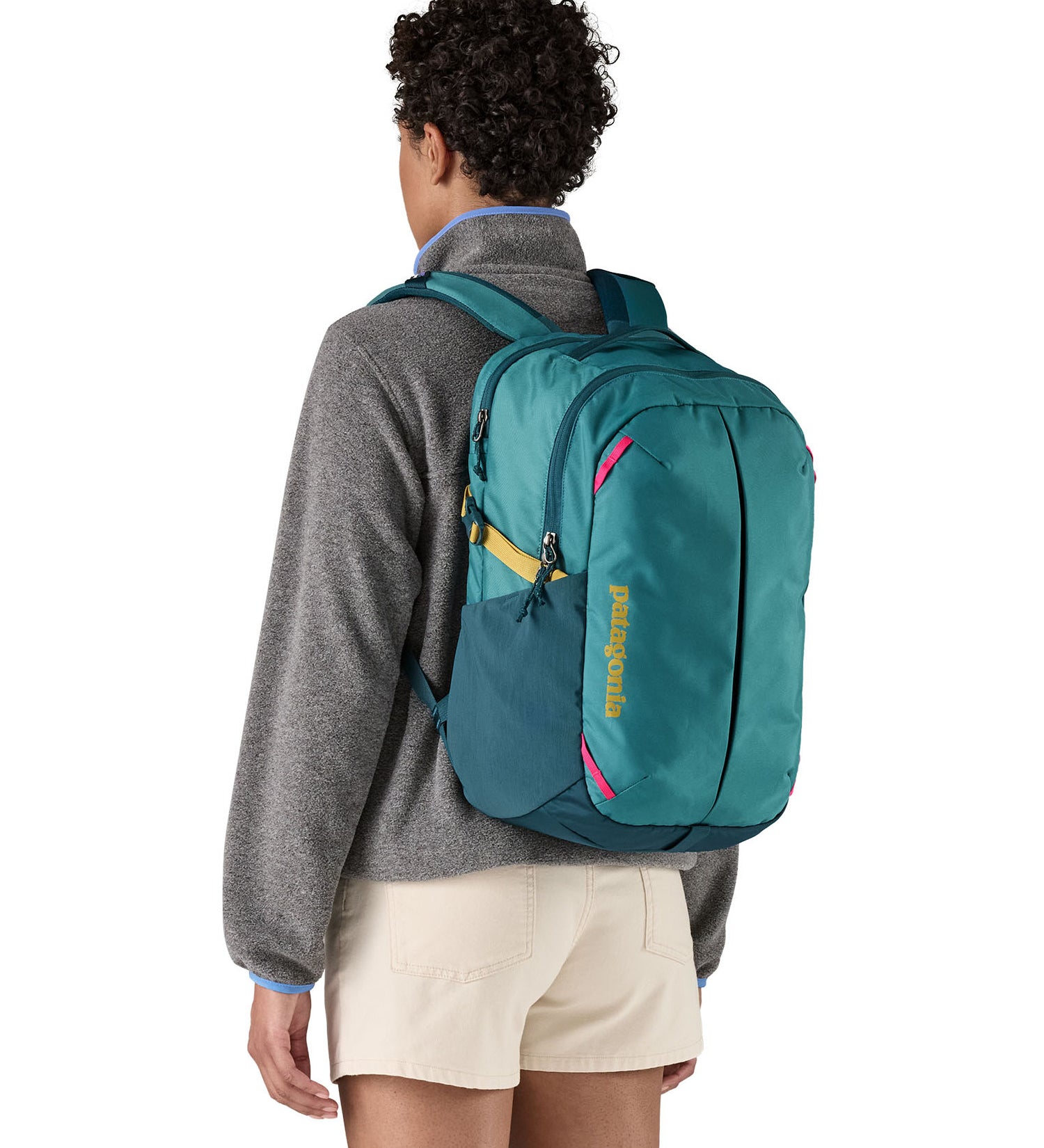Patagonia turquoise 26L day refugio backpack worn by an adult