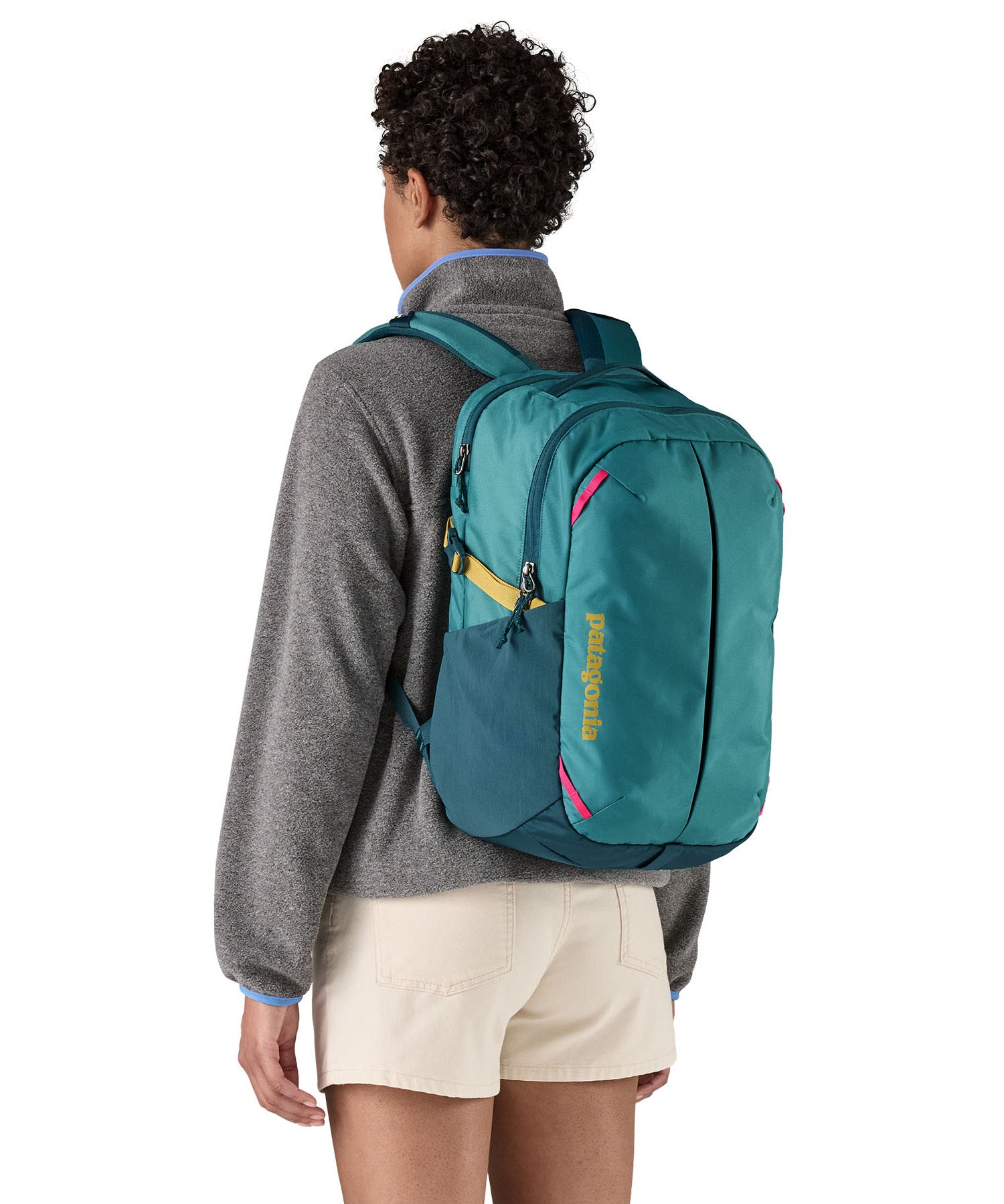 Patagonia turquoise 26L day refugio backpack worn by an adult