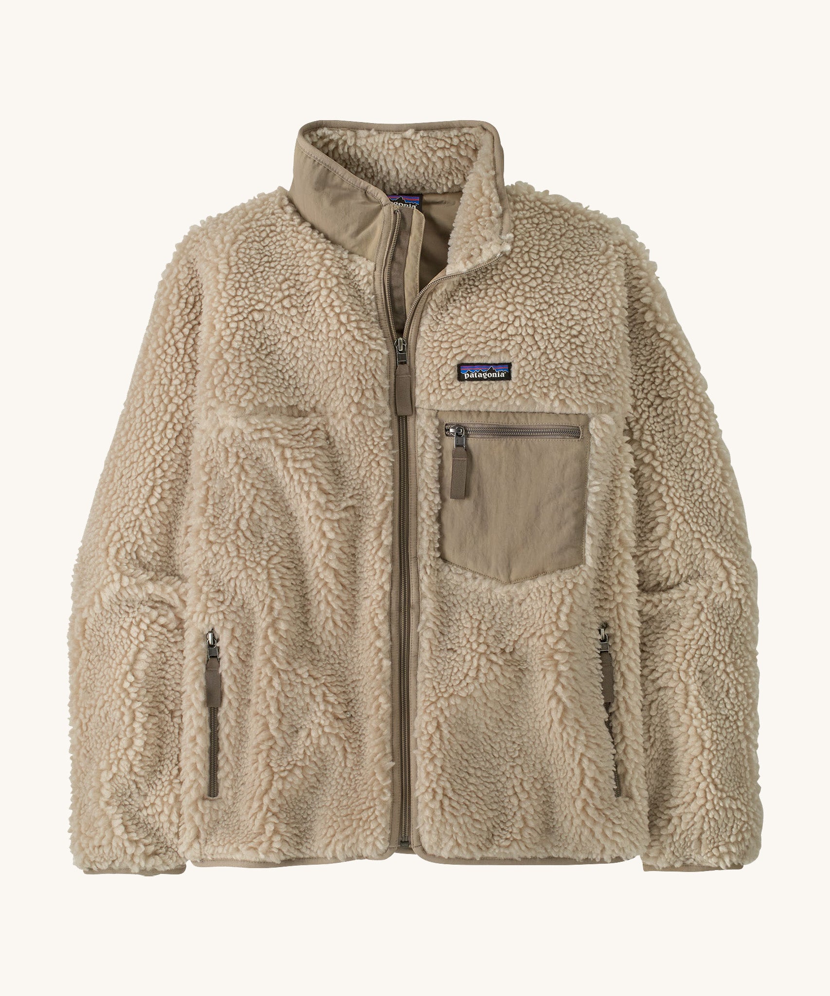Patagonia womens retro-x jacket. A thick natural colour fleece. Features a full length zip, chest and side pockets and a logo patch stitched on the left chest.
