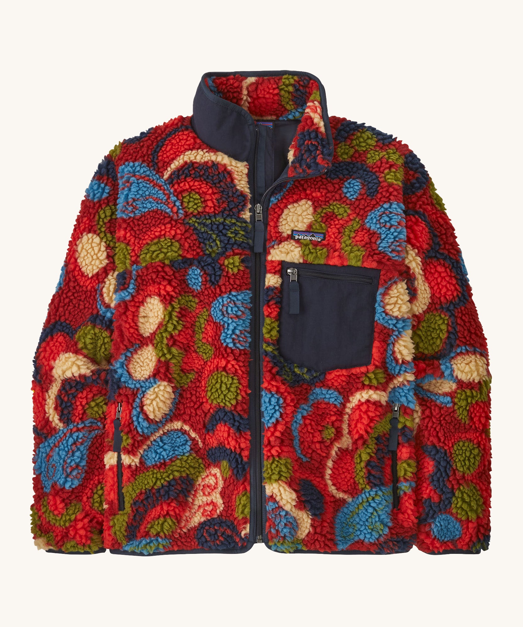 Patagonia womens retro-x jacket. A thick red fleece in red with different colour shapes all over. Features a navy full length zip, chest pocket and a logo patch stitched on the left chest.
