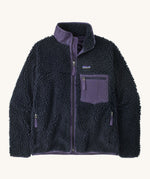 Patagonia womens retro-x jacket. A thick navy fleece and features a dark purple full length zip, chest pocket, side pockets and a logo patch stitched on the left chest.