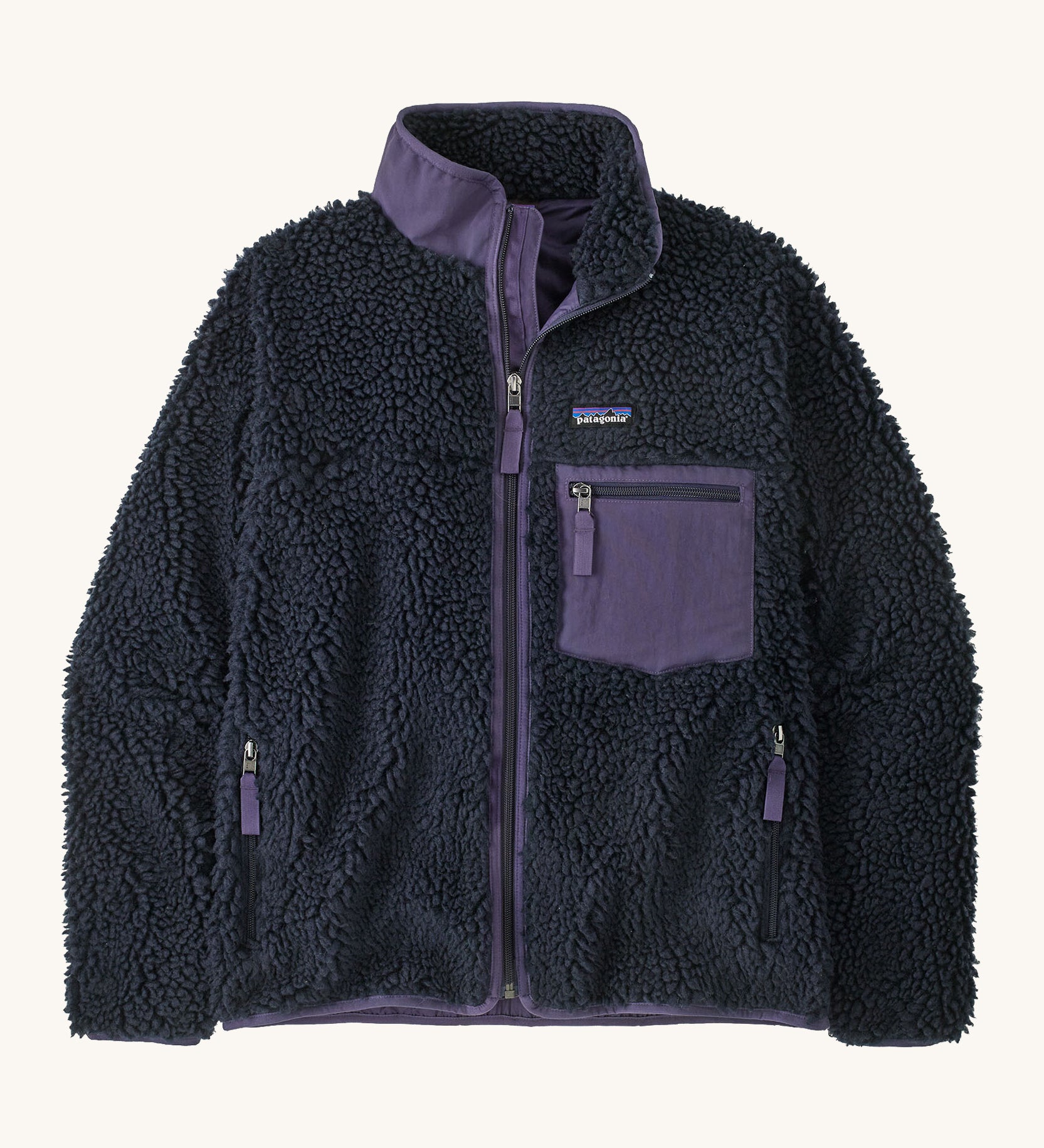 Patagonia womens retro-x jacket. A thick navy fleece and features a dark purple full length zip, chest pocket, side pockets and a logo patch stitched on the left chest.