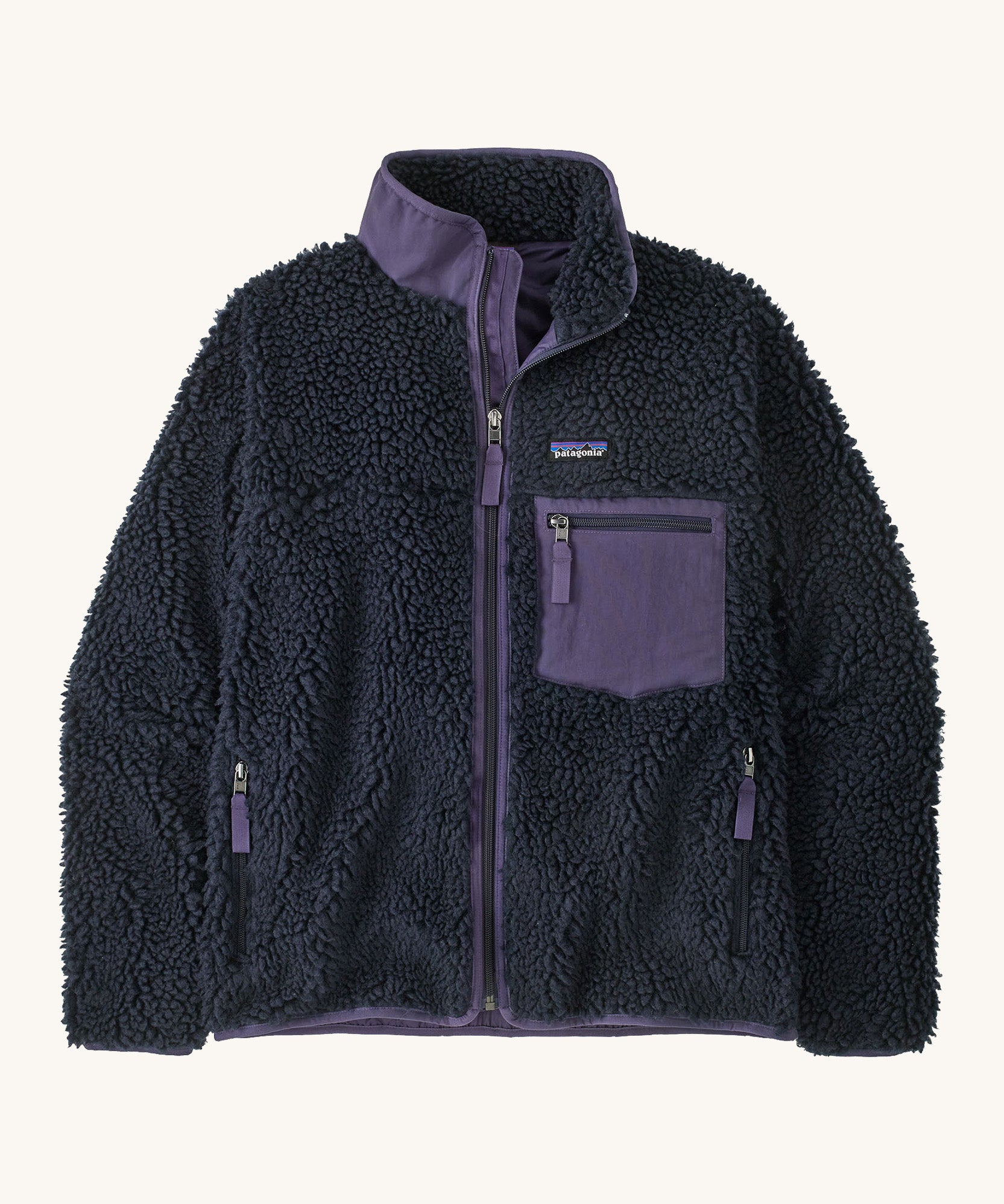 Patagonia womens retro-x jacket. A thick navy fleece and features a dark purple full length zip, chest pocket, side pockets and a logo patch stitched on the left chest.
