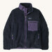 Patagonia womens retro-x jacket. A thick navy fleece and features a dark purple full length zip, chest pocket, side pockets and a logo patch stitched on the left chest.