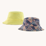 Patagonia reversible baby sun bucket hat with all over jaggy style faded magenta print on one side and plain light lime green on the other.