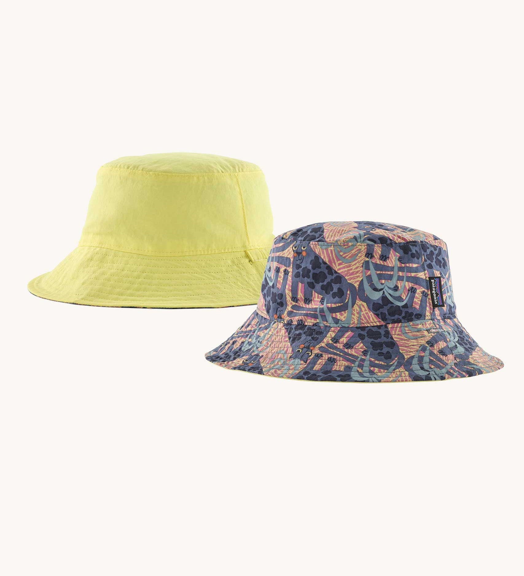 Patagonia reversible baby sun bucket hat with all over jaggy style faded magenta print on one side and plain light lime green on the other.