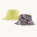 Patagonia reversible baby sun bucket hat with all over jaggy style faded magenta print on one side and plain light lime green on the other.