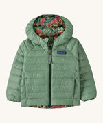 Patagonia little kids down hooded jacket in cascade green/see saw owl. A light green warm reversible jacket with a owl design on the reversible side. Features a a full length zip and 2 side pockets.