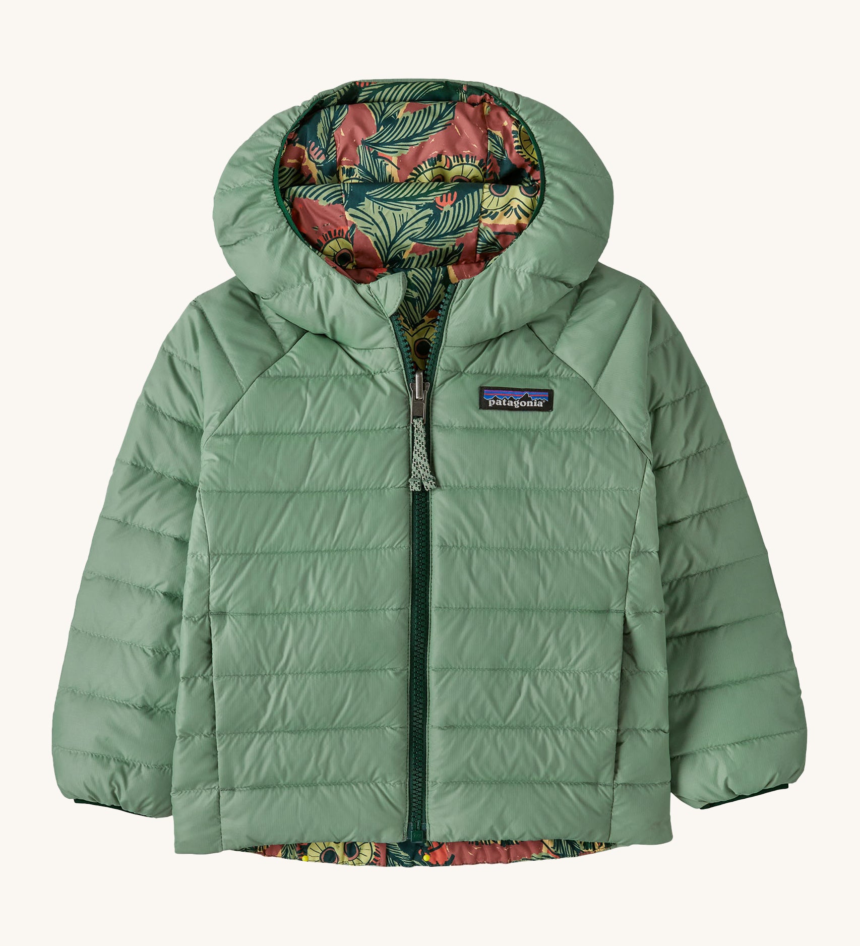 Patagonia little kids down hooded jacket in cascade green/see saw owl. A light green warm reversible jacket with a owl design on the reversible side. Features a a full length zip and 2 side pockets.