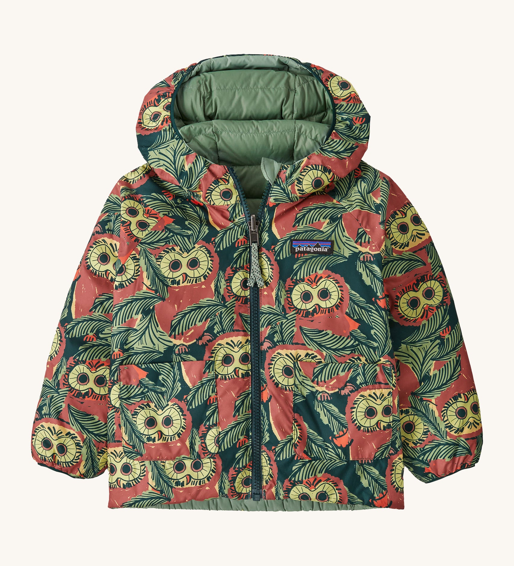 Patagonia little kids down hooded jacket in cascade green/see saw owl. A light warm reversible jacket with a bold funky owl design and  light green on the reversible side. Features a a full length zip and 2 side  pouch pockets