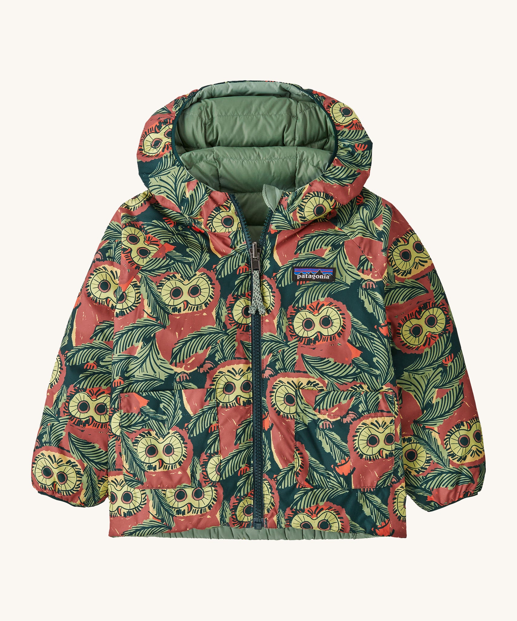 Patagonia little kids down hooded jacket in cascade green/see saw owl. A light warm reversible jacket with a bold funky owl design and  light green on the reversible side. Features a a full length zip and 2 side  pouch pockets
