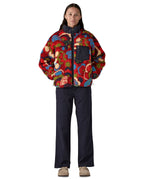 Full view of the Patagonia river river amanita red retro fleece jacket worn by an adult. 