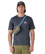 Patagonia Terravia Mini Hip Pack in a  river rock green colour worn by an adult on the shoulder